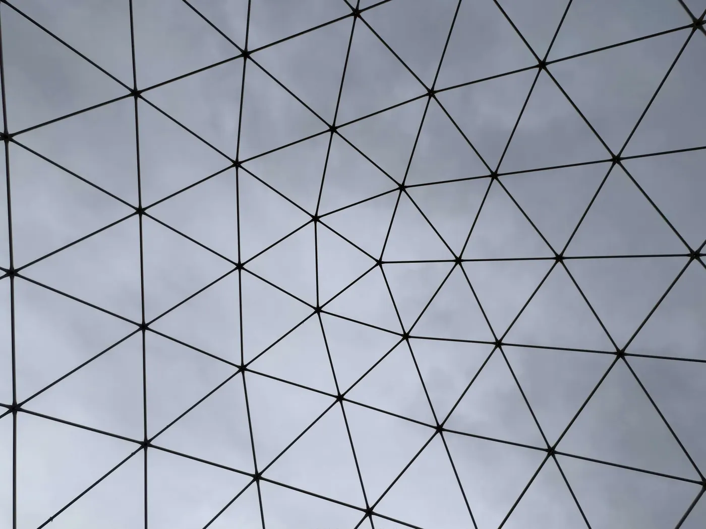A triangulated architectural space-frame against the sky: the engineered lattice that structures the strategy into an accessible note.